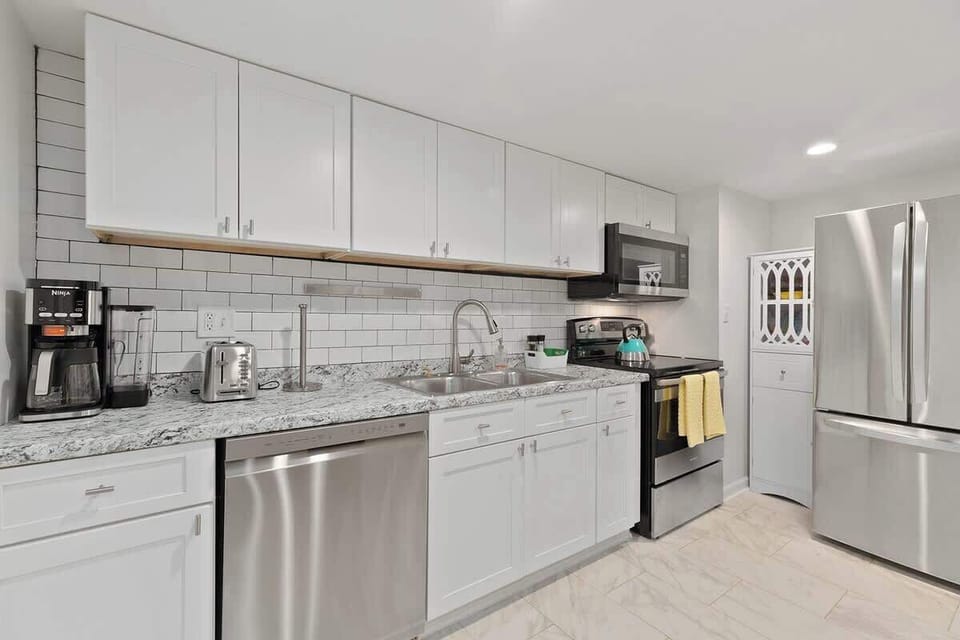Modern Appliances: The kitchen features sleek, stainless steel appliances, including a state-of-the-art oven and microwave, ensuring a convenient cooking experience.