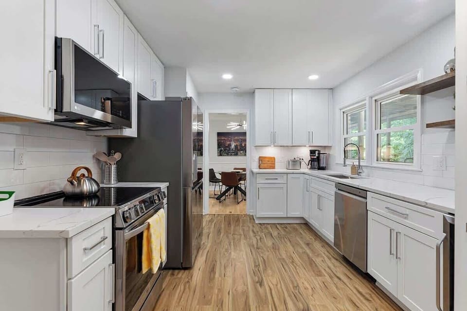 Modern Appliances: The kitchen features sleek, stainless steel appliances, including a state-of-the-art oven and microwave, ensuring a convenient cooking experience.