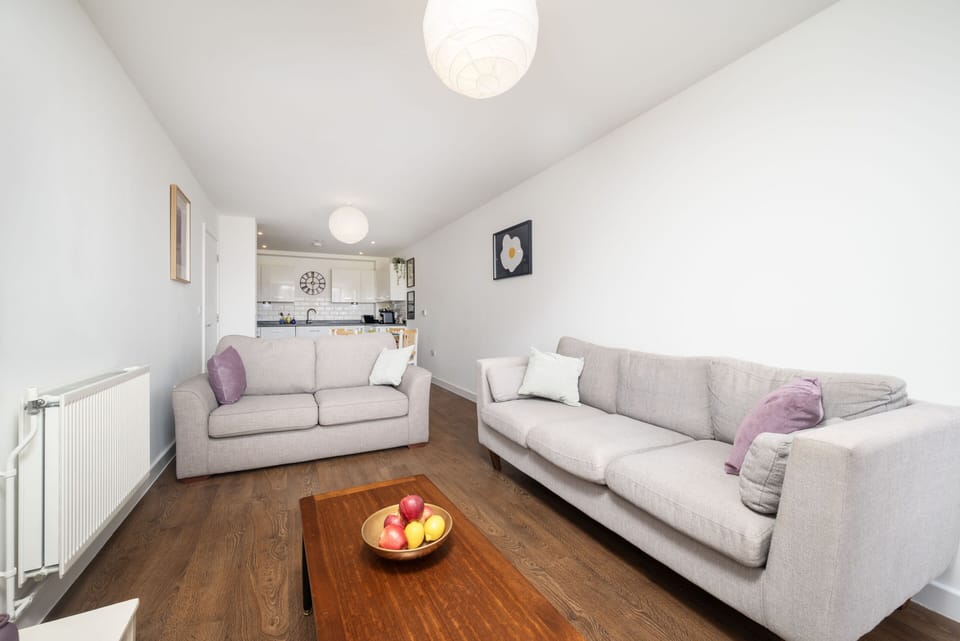A spacious, naturally lit living space with warm wood finishes and cozy seating—ideal for relaxing or entertaining.
