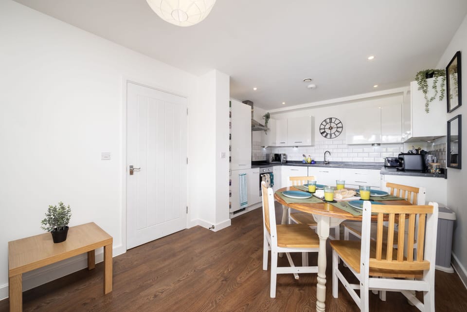 Bright and modern kitchen at the Stylish Bickley Home Near London. Featuring a fully equipped cooking space, dining area, and contemporary design for a comfortable stay.