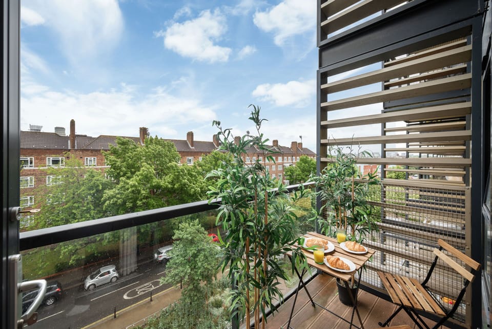 A stylish outdoor space with seating where you can enjoy fresh air, sip your morning coffee, or unwind in the evening while taking in views of the neighborhood.