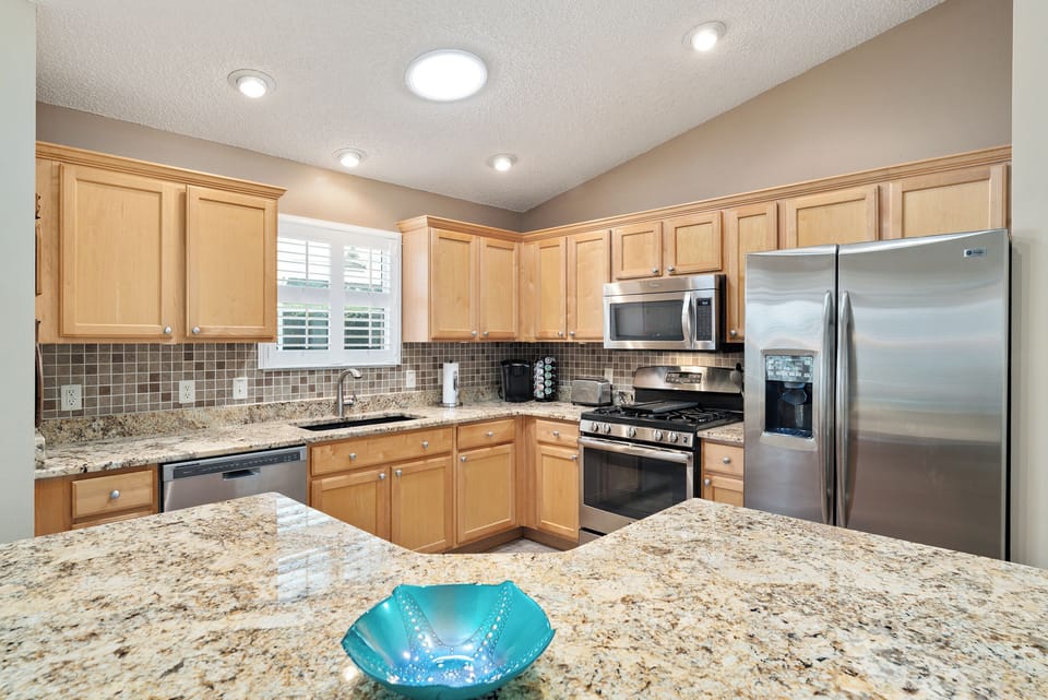 Stainless Steel Appliances Including Ice/Water Dispenser on the Fridge