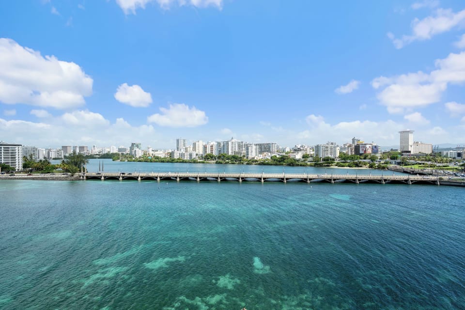 Behold the magnificent Condado Lagoon, a vibrant centerpiece of our locale. This panoramic view showcases the serene waters, lush surroundings, and the iconic bridge, inviting you to explore the beauty of San Juan from above.