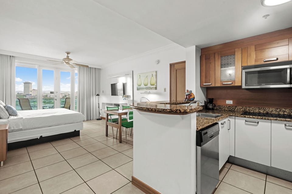 Experience the best of open-concept living in this inviting studio. From the fully equipped kitchenette and comfortable bed to the dining area and stunning balcony views, every element is curated for a delightful and memorable stay.