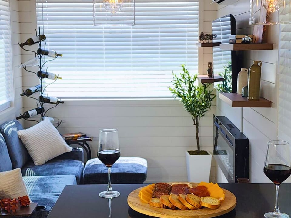 Living Room: Sip wine by the electric fireplace amidst chic décor and natural light!