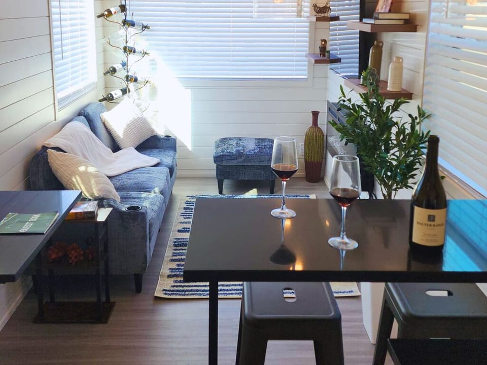 Living Room Retreat: Sip wine in style with chic decor and inviting sunlight streaming in!