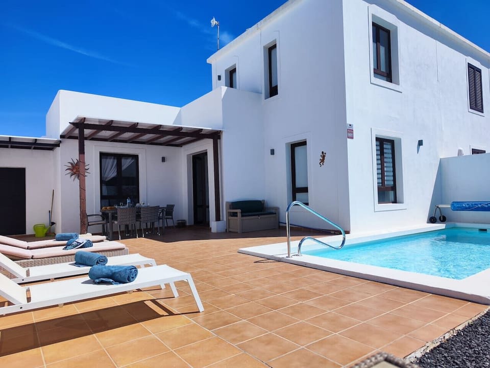 Terraza soleada con tumbonas, zona chill out y porche techado