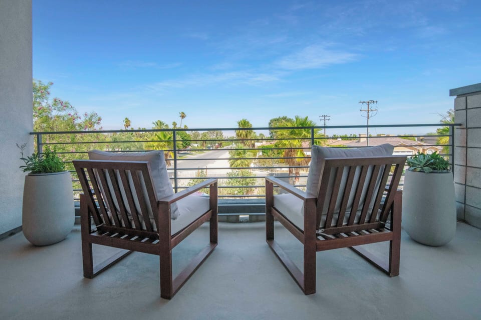 Private upstairs balcony with palm views and comfortable seating