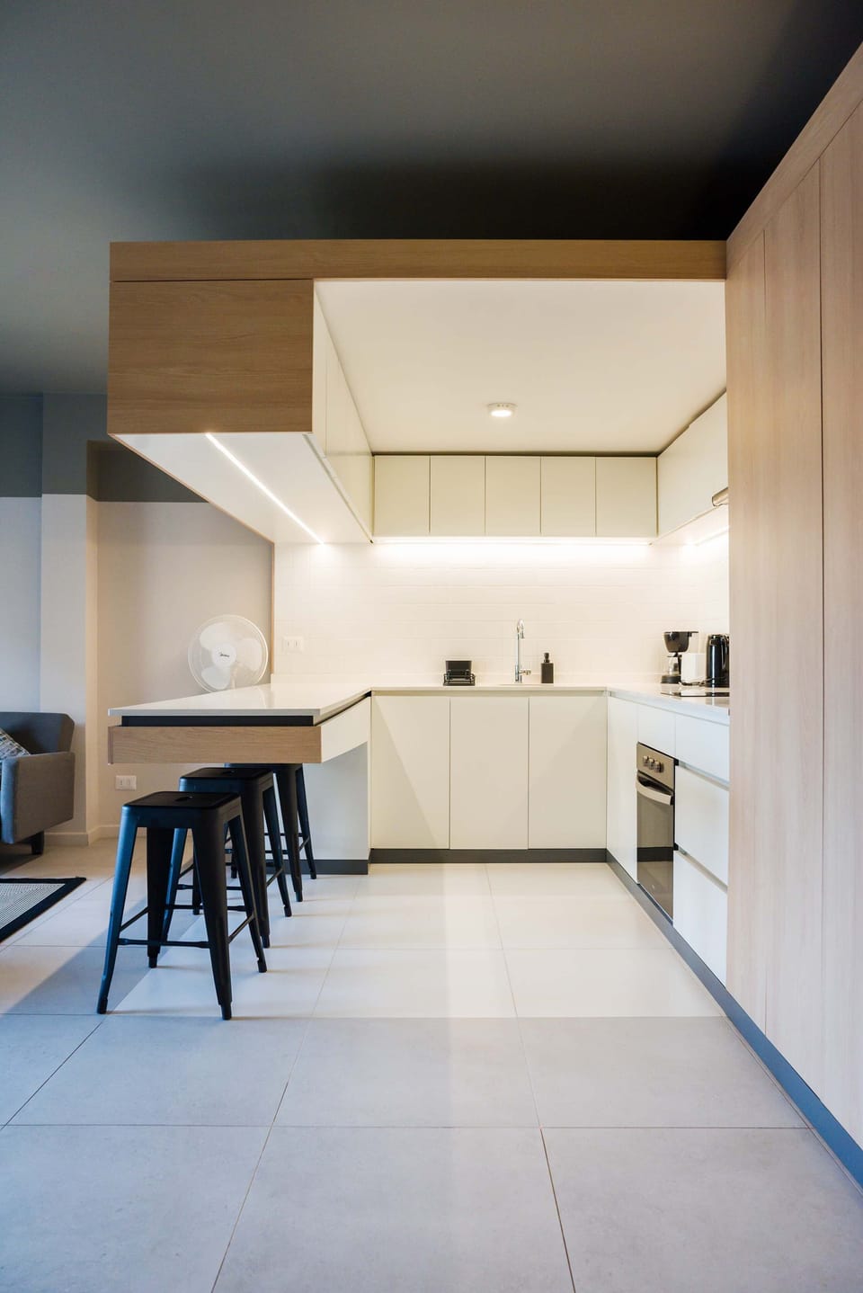 Sleek and modern kitchen with bar seating, perfect for enjoying a cozy meal in your private studio apartment.