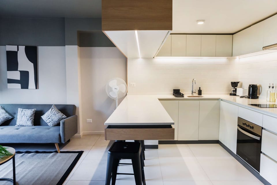 Experience modern living in this stylish studio with a sleek kitchen and cozy lounge area, perfect for your stay in Chile.