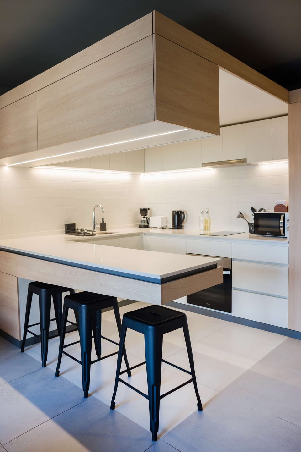 Sleek and modern kitchen with all essentials for a comfortable stay, perfect for cooking and dining in style.