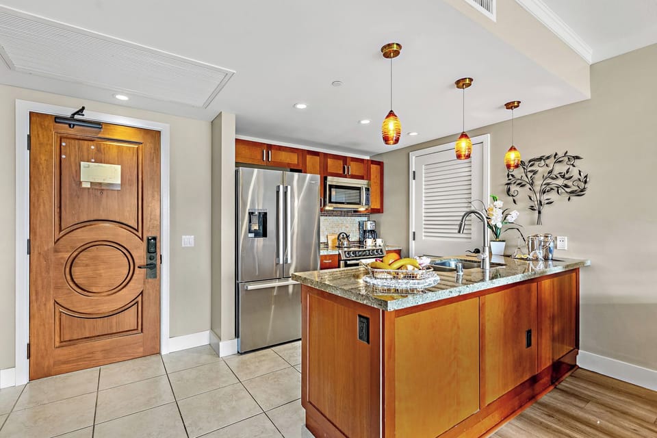 Your gourmet kitchen features granite countertops, stainless appliances, and warm wood cabinetry, creating the perfect space for your culinary adventures.