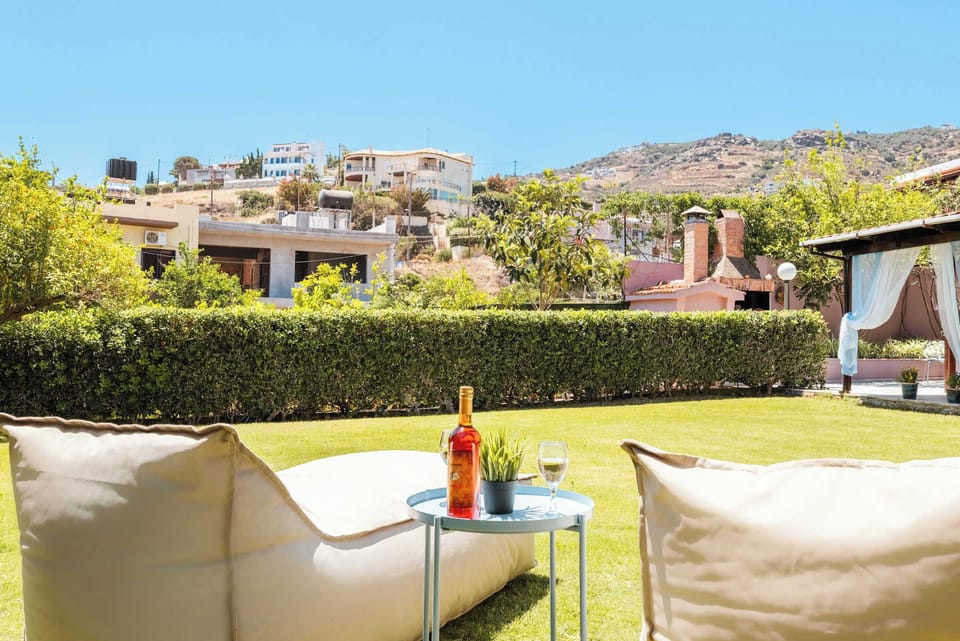 Sip a drink and enjoy the sunny garden with mountain views in the background.