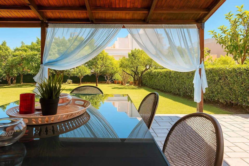 Relax in the shade of our breezy patio, surrounded by lush gardens, perfect for enjoying the outdoors.