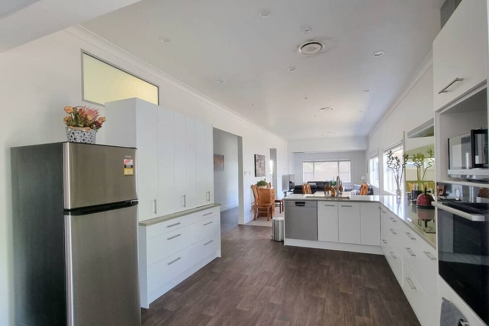 A large modern kitchen with plenty of space for storage, with all the modern conveniences and appliances that you would expect in a home of this standard.
