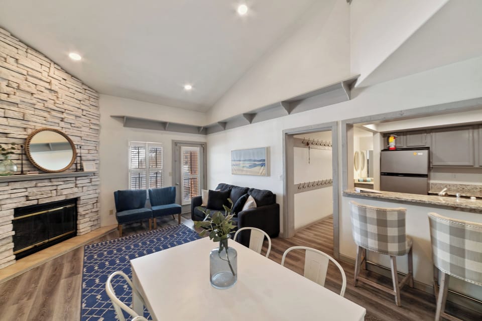 Spacious living room featuring a wood-burning fireplace, smart TV, and comfortable furniture—perfect for relaxing after a day on the mountain