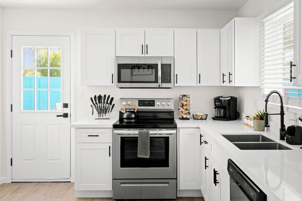 Fully equipped kitchen with coffee bar, tea, microwave, oven, stove, dishwasher