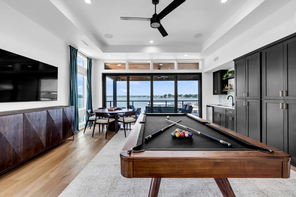 Game room with pool table, dartboard, game table, laundry closet, Smart TV and balcony 