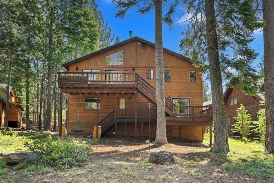 Back of Cabin with Hot Tub and outdoor furniture in the warmer months.