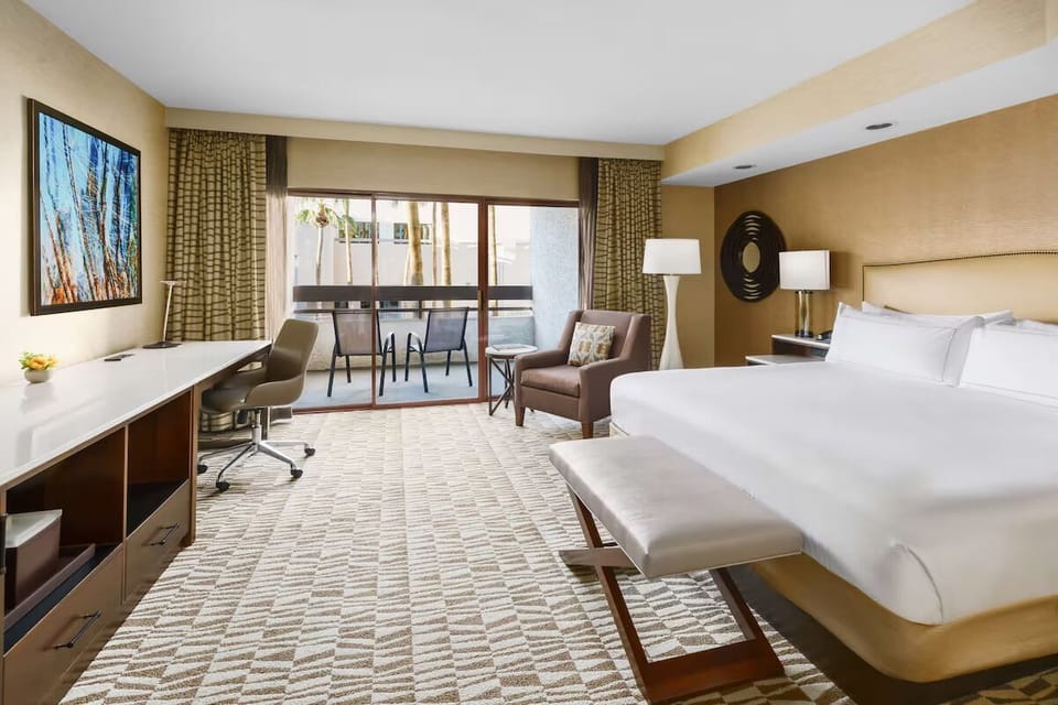 Unwind in a spacious king room with balcony daylight.