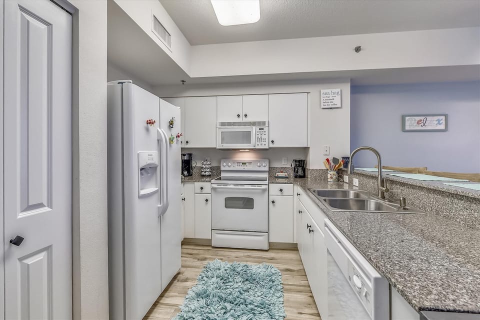 Kitchen with granite counter tops and large fridge/freezer