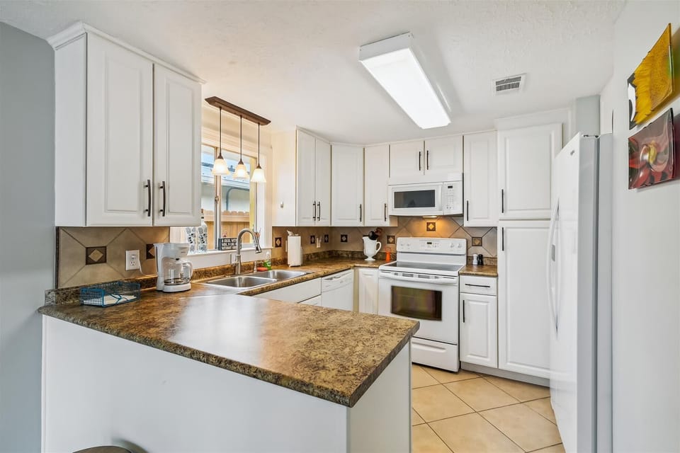 fully stocked kitchen with standard coffee maker