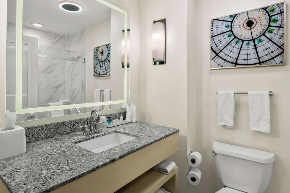 Refresh under bright lights with a spotless granite vanity.