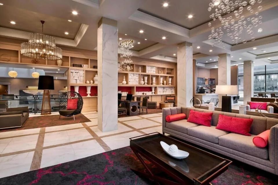 Relax into modern comfort beneath sparkling chandeliers and warm lighting.