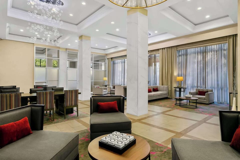 Unwind in the soaring lounge with plush seating and daylight.