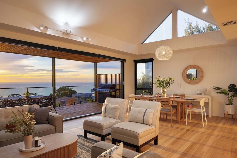 Ground level living room, dining table and outdoor seating view.