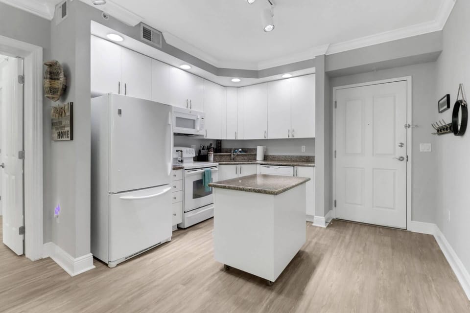 The open kitchen is well equipped with full-sized oven, microwave, refrigerator/freezer and dishwasher.