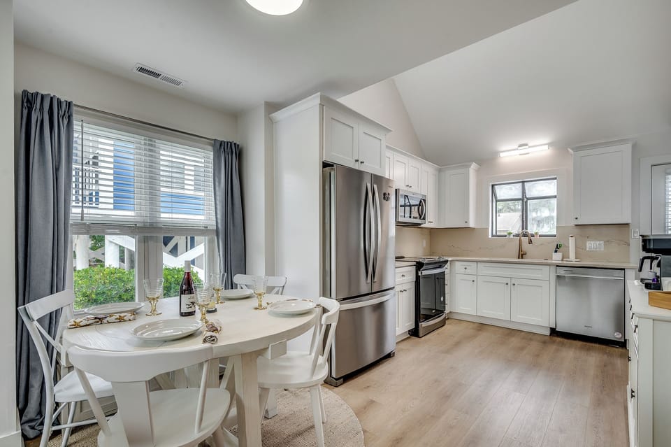 Sunny sips and stylish bites! Dine by the window in this light-filled space, just steps from the sleek, modern kitchen.