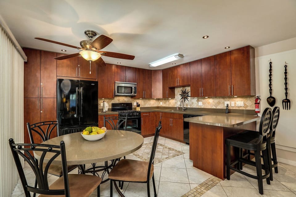 Fully equipped kitchen with stainless appliances and breakfast bar