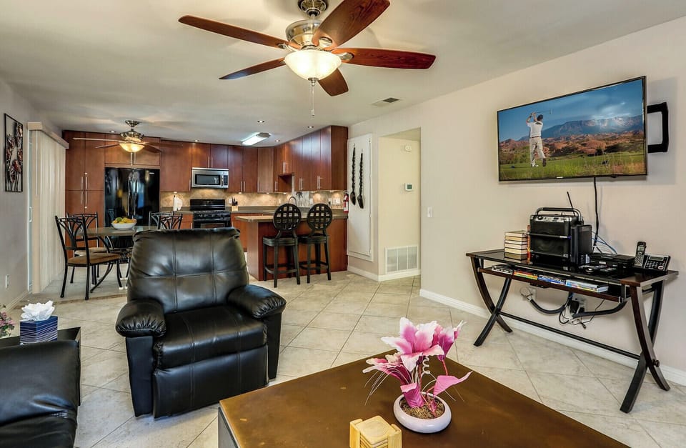 Living room flows into modern kitchen with bar seating