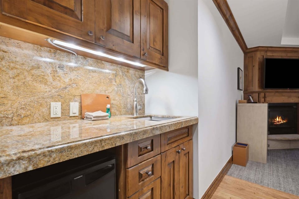 Primary Bedroom with attached bathroom, fireplace, mini bar