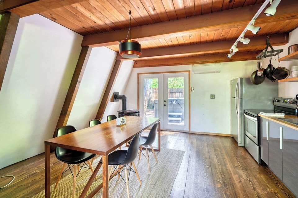 Dining room with kitchen and deck doors.