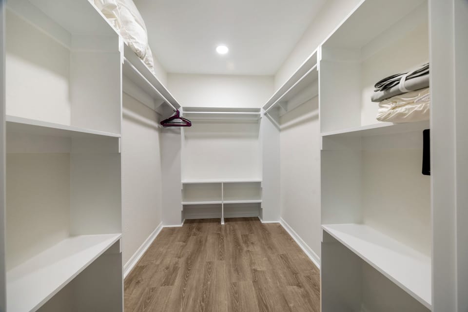 Master closet with new linens and plenty of cloth hangers