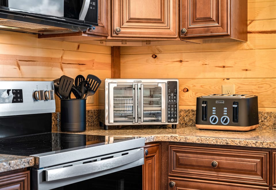 Kitchen with stainless steel appliances and all the essentials for home cooked meals. (House 1)
