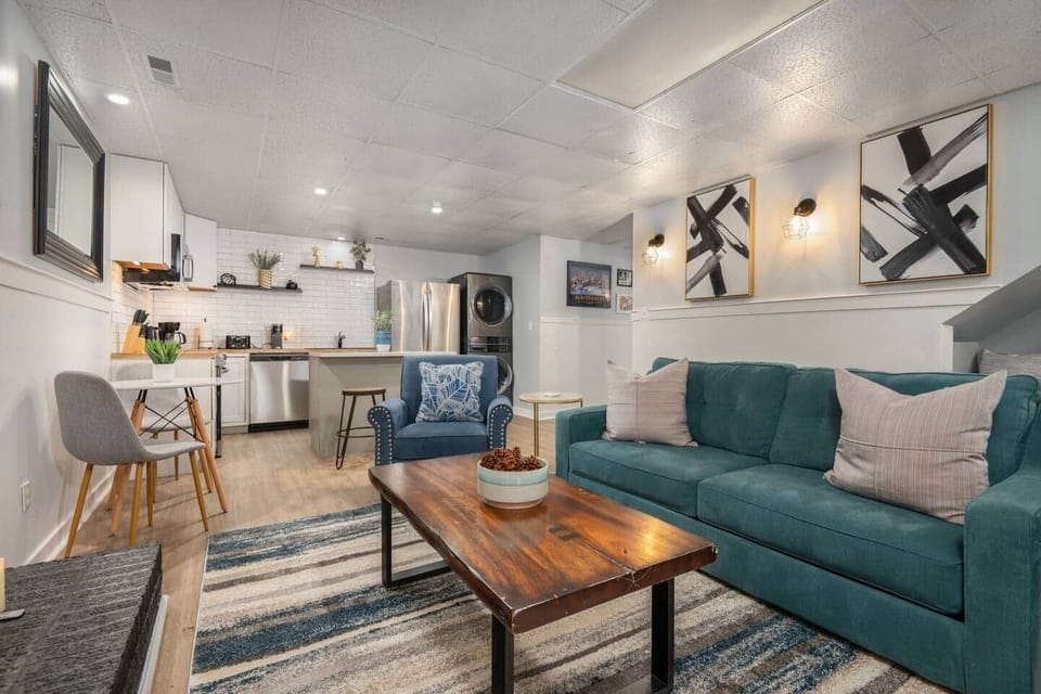 Cozy basement living room with a Smart TV for movie nights and an air hockey table for a little friendly competition. The perfect space to unwind or play.