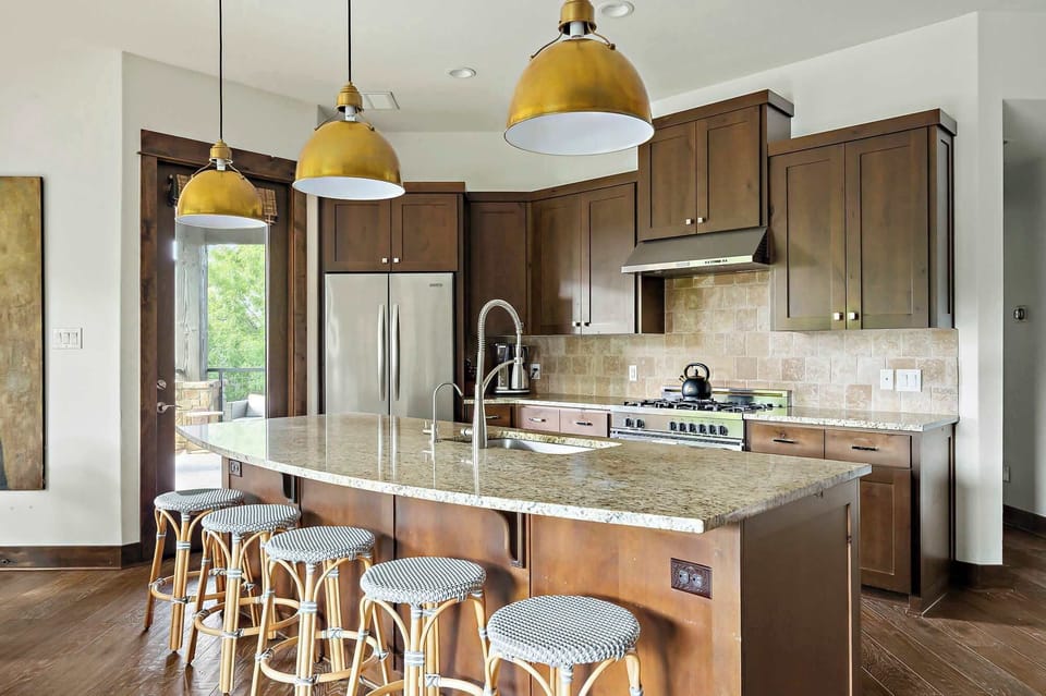 The fully equipped kitchen is ideal for everything from quick breakfasts to full dinners, complete with a breakfast bar and a dining table that seats eight for memorable meals and gatherings.