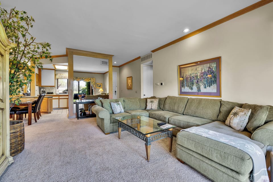 Open-concept living room flowing into kitchen and dining area