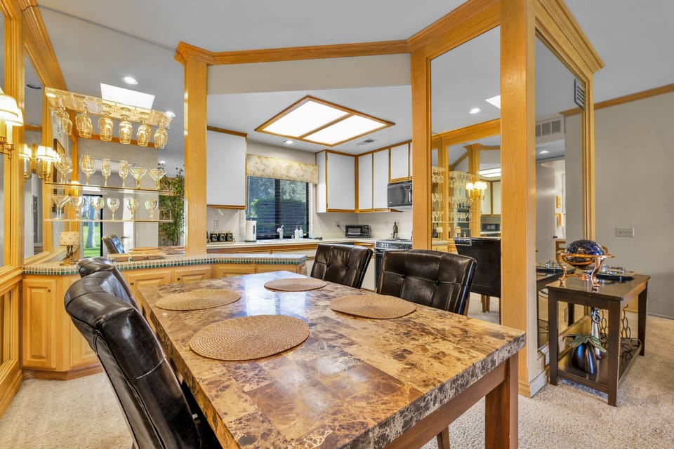 Dining area with marble-top table and open kitchen layout