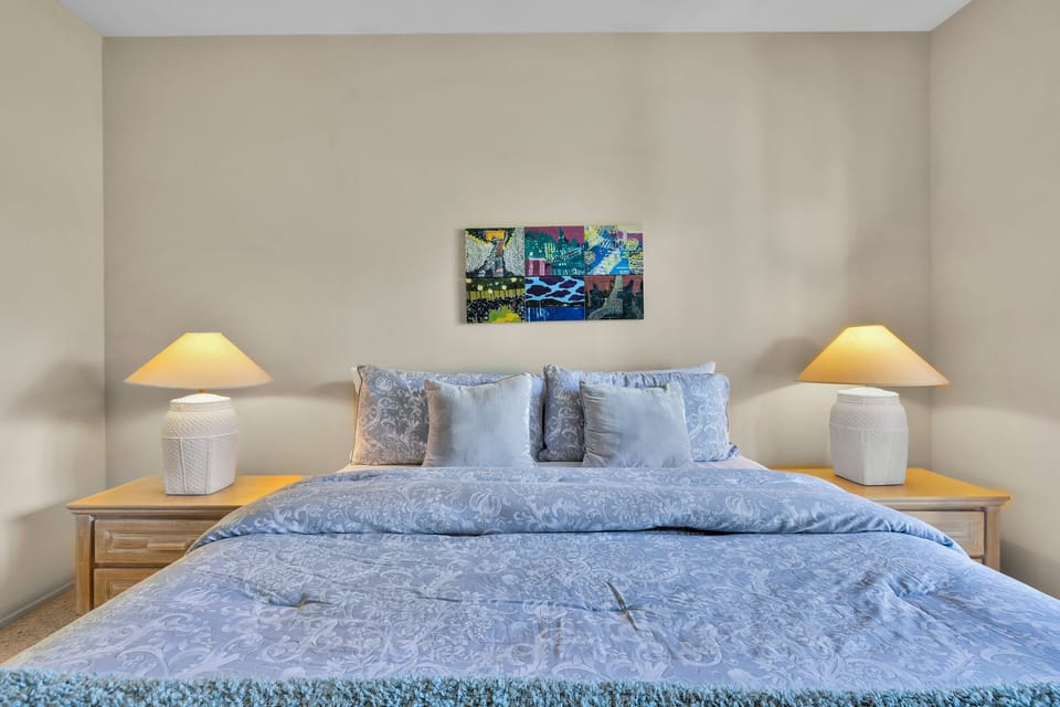 Guest bedroom with cozy bedding and bedside lighting