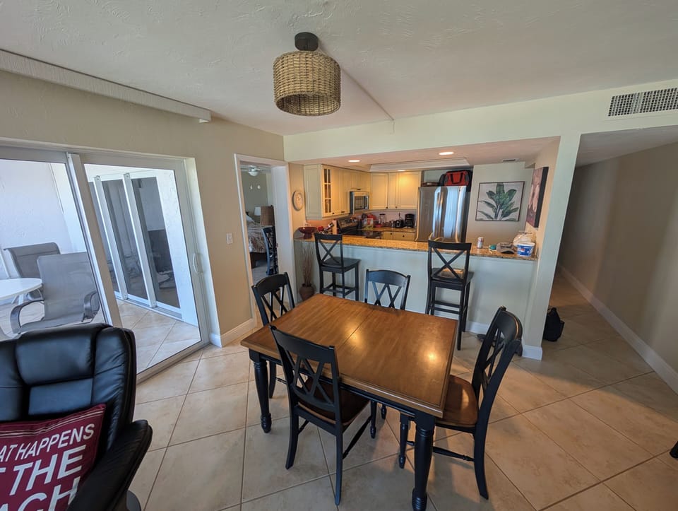 Dining table and access to lania with ocean view.