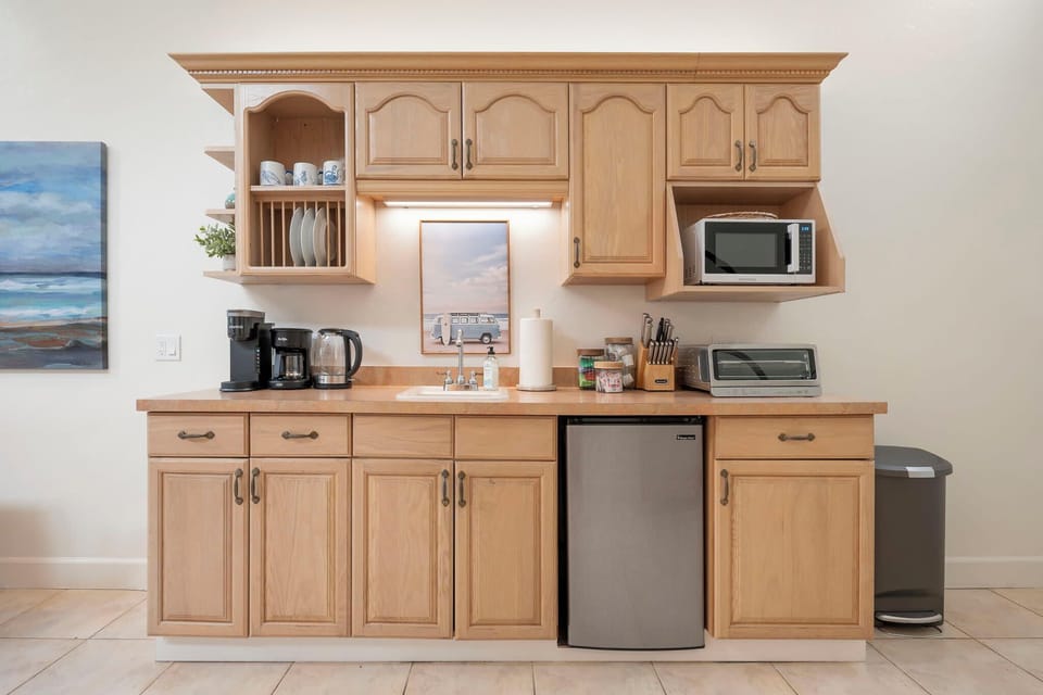 Well-equipped kitchen with coffee maker, microwave, toaster, and mini fridge