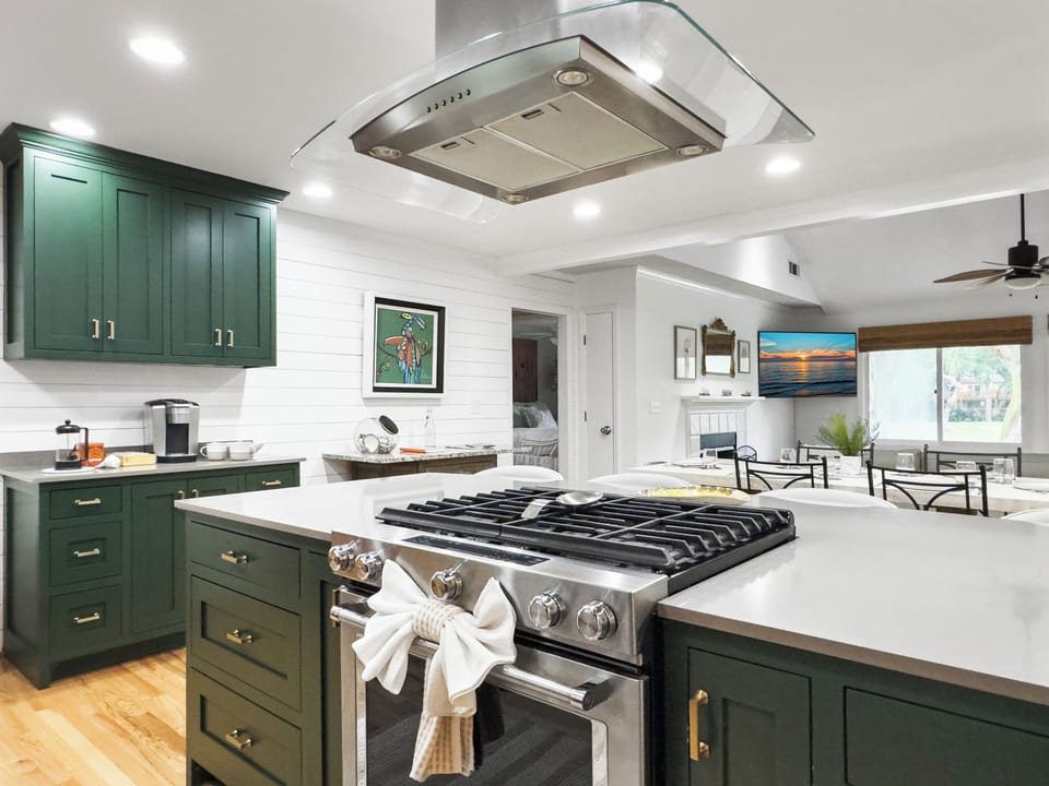 Gorgeous gas stove and huge island for making meals.