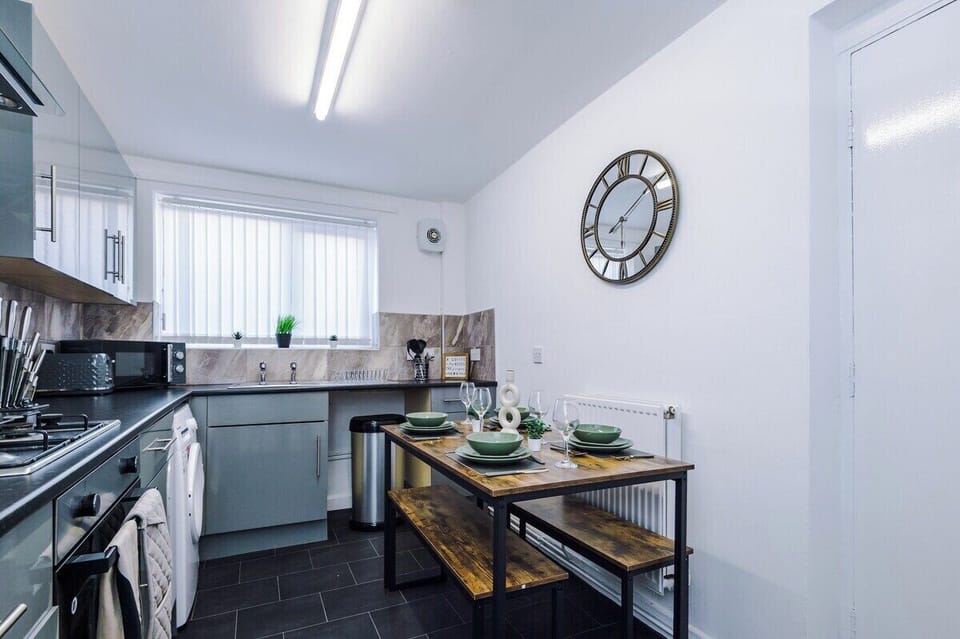 Whip up meals with ease in this modern space with calming green accents.