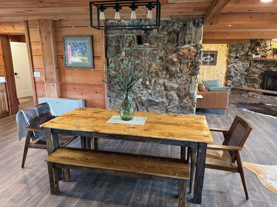 Dining table adjacent to open-area kitchen and island