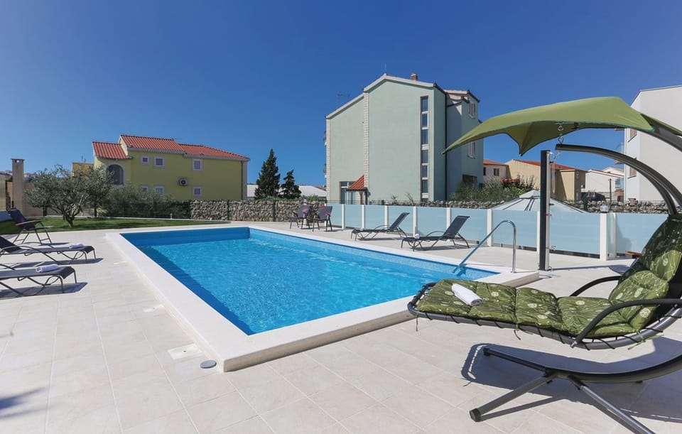 Outdoor pool with sun loungers