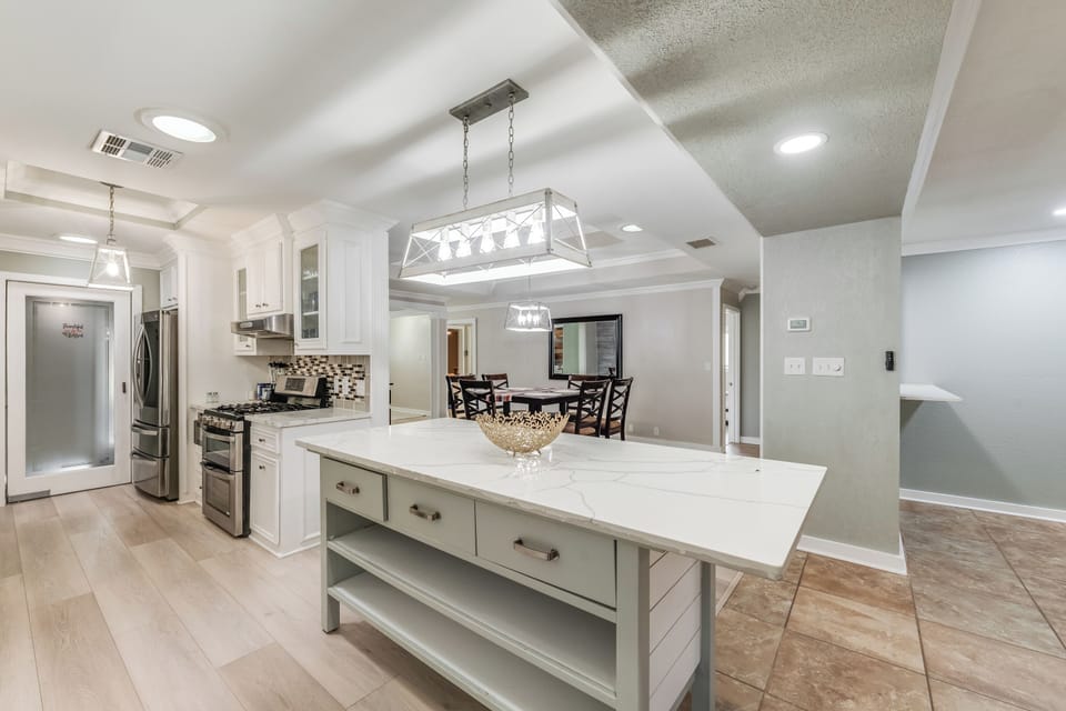 Spacious kitchen with large island, perfect for family meals or entertaining guests.